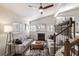 Bright living room featuring a fireplace, plush seating and a modern ceiling fan at 1000 Bozeman Dr, Atlanta, GA 30341