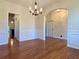 Formal dining room boasts an elegant chandelier, wainscoting, and hardwood floors, creating an inviting space at 107 Deer Park Dr, Carrollton, GA 30116