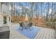 Outdoor back deck with table and chairs on a vibrant blue patterned area rug at 2086 Mountain Creek Ct, Stone Mountain, GA 30087