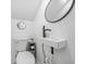 Cozy bathroom featuring a vessel sink, round mirror, and modern fixtures at 2086 Mountain Creek Ct, Stone Mountain, GA 30087