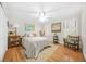 Bright bedroom with hardwood floors, ceiling fan, and natural light from windows at 2086 Mountain Creek Ct, Stone Mountain, GA 30087