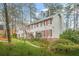 A lovely home with red shutters and beautiful landscaping, nestled among mature trees at 2086 Mountain Creek Ct, Stone Mountain, GA 30087