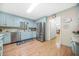 Bright kitchen with stainless steel appliances, light blue cabinets, and hardwood floors for a fresh look at 2086 Mountain Creek Ct, Stone Mountain, GA 30087