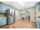 Well-lit kitchen with stainless steel appliances, light blue cabinetry, and an adjacent breakfast area at 2086 Mountain Creek Ct, Stone Mountain, GA 30087