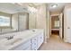 Bright primary bathroom featuring double sinks, vanity, and tiled floors at 501 Barhams Ridge Dr, Mcdonough, GA 30252