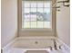 Relaxing bathroom featuring a deep soaking tub and natural light at 501 Barhams Ridge Dr, Mcdonough, GA 30252