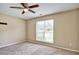 This cozy bedroom features neutral walls, plush carpet, and a ceiling fan for added comfort at 501 Barhams Ridge Dr, Mcdonough, GA 30252