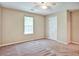 Sunlit bedroom with a ceiling fan and neutral walls with carpet flooring at 501 Barhams Ridge Dr, Mcdonough, GA 30252