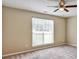 This cozy bedroom features neutral walls, plush carpet, and a ceiling fan for added comfort at 501 Barhams Ridge Dr, Mcdonough, GA 30252