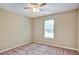 Spacious bedroom featuring neutral walls, carpet flooring, and a ceiling fan at 501 Barhams Ridge Dr, Mcdonough, GA 30252