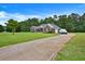 Wide driveway leading to a brick home with a beautiful lawn and mature trees in a desirable neighborhood at 501 Barhams Ridge Dr, Mcdonough, GA 30252
