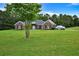 Charming one-story brick home features a spacious front yard, black shutters, and a welcoming entrance at 501 Barhams Ridge Dr, Mcdonough, GA 30252