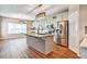 Modern kitchen features stainless steel appliances, pendant lighting, and granite countertops in an open layout at 501 Barhams Ridge Dr, Mcdonough, GA 30252