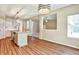 Open-concept living room boasts hardwood floors and natural light from large windows at 501 Barhams Ridge Dr, Mcdonough, GA 30252