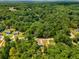 An aerial view showcases a home nestled in a lush, wooded area with mature trees at 3989 Woodland Se Cir, Conyers, GA 30013