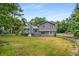 View of the large backyard with a partially fenced in perimeter at 3989 Woodland Se Cir, Conyers, GA 30013