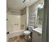Compact bathroom with tub shower, toilet, and neutral colored vanity at 3989 Woodland Se Cir, Conyers, GA 30013