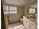 Neutral-toned bathroom featuring a sink vanity, window and tile flooring at 3989 Woodland Se Cir, Conyers, GA 30013