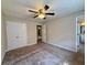 The bedroom includes a closet, carpet, neutral walls, and a doorway to the en-suite bathroom at 3989 Woodland Se Cir, Conyers, GA 30013