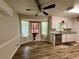 Bright dining area with bay window, wood floors, and modern lighting next to the kitchen at 3989 Woodland Se Cir, Conyers, GA 30013