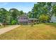 Charming gray split-level home with a welcoming front porch and well-maintained lawn at 3989 Woodland Se Cir, Conyers, GA 30013