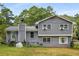 The home's exterior features a mix of siding and a yard with a partially fenced in area at 3989 Woodland Se Cir, Conyers, GA 30013