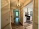 Hallway view leading to a kitchen with white cabinets and stainless steel appliances at 3989 Woodland Se Cir, Conyers, GA 30013