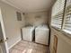 Clean laundry room with washer, dryer, and tile floor at 3989 Woodland Se Cir, Conyers, GA 30013