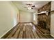 Bright living room featuring a stone fireplace, vaulted ceilings, and wood flooring at 3989 Woodland Se Cir, Conyers, GA 30013