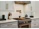 Close up of a bright kitchen featuring stainless steel appliances, white cabinets, and subway tile backsplash at 455 Glen Iris Ne Dr # U, Atlanta, GA 30308