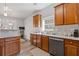 Well-lit kitchen with stainless steel appliances, granite countertops, and wood cabinets at 109 Mill Creek Dr, Canton, GA 30115