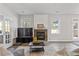 Cozy living room with a stone fireplace, modern furniture, and lots of natural light at 109 Mill Creek Dr, Canton, GA 30115