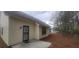 Exterior of the home featuring vinyl siding and a concrete patio at 1956 Cutters Mill Way, Lithonia, GA 30058