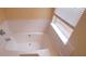 This bathroom features a soaking tub with a window, providing a relaxing and bright space at 1956 Cutters Mill Way, Lithonia, GA 30058