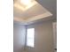 Bedroom featuring a tray ceiling, and a large window providing an abundance of natural light at 1956 Cutters Mill Way, Lithonia, GA 30058