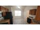View of kitchen with wood cabinets, gray linoleum flooring, and a breakfast area at 1956 Cutters Mill Way, Lithonia, GA 30058