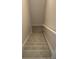 A carpeted staircase with white trim and beige walls at 1956 Cutters Mill Way, Lithonia, GA 30058