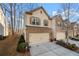 Charming two-story townhouse featuring a brick facade, two-car garage, and well-maintained landscaping at 2515 Norwood Park Xing, Atlanta, GA 30340