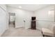 Hallway with neutral carpet features an antique record player, chair, and access to additional rooms at 2515 Norwood Park Xing, Atlanta, GA 30340