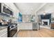 Modern kitchen featuring white cabinets, granite countertops, stainless steel appliances, and an open layout at 2515 Norwood Park Xing, Atlanta, GA 30340