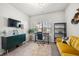 Bright home office with large window, modern light fixtures and yellow sofa at 2515 Norwood Park Xing, Atlanta, GA 30340