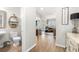 Stylish powder room featuring wood floors, a modern sink, toilet, and decorative shelving at 2515 Norwood Park Xing, Atlanta, GA 30340