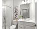 Bright bathroom with white cabinets, a framed mirror, and a glass shower at 3192 Eastham Run Dr, Dacula, GA 30019