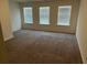 Bedroom with neutral carpet, three windows with blinds, and white walls at 4353 Morning Vw, Stone Mountain, GA 30083