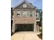 Townhome garage with open door and brick facade above at 4353 Morning Vw, Stone Mountain, GA 30083