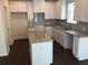 Kitchen with white cabinets, granite countertops, stainless steel sink and dark wood floors at 4353 Morning Vw, Stone Mountain, GA 30083