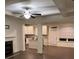 Open living room with fireplace, white trim, and hardwood floors flowing into the kitchen at 4353 Morning Vw, Stone Mountain, GA 30083