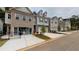 Row of modern townhomes with brick and siding exteriors with driveways and landscaping on a cloudy day at 4353 Morning Vw, Stone Mountain, GA 30083