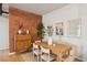 Dining area with modern decor, a brick accent wall, and ample natural light provides a welcoming space at 5300 Peachtree Rd # 0507, Atlanta, GA 30341