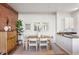 Bright dining area with brick accent wall, modern table with seating for six, and updated kitchen nearby at 5300 Peachtree Rd # 0507, Atlanta, GA 30341